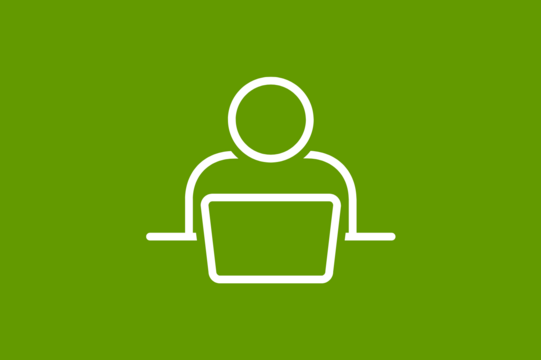 A person sits at a laptop and works.